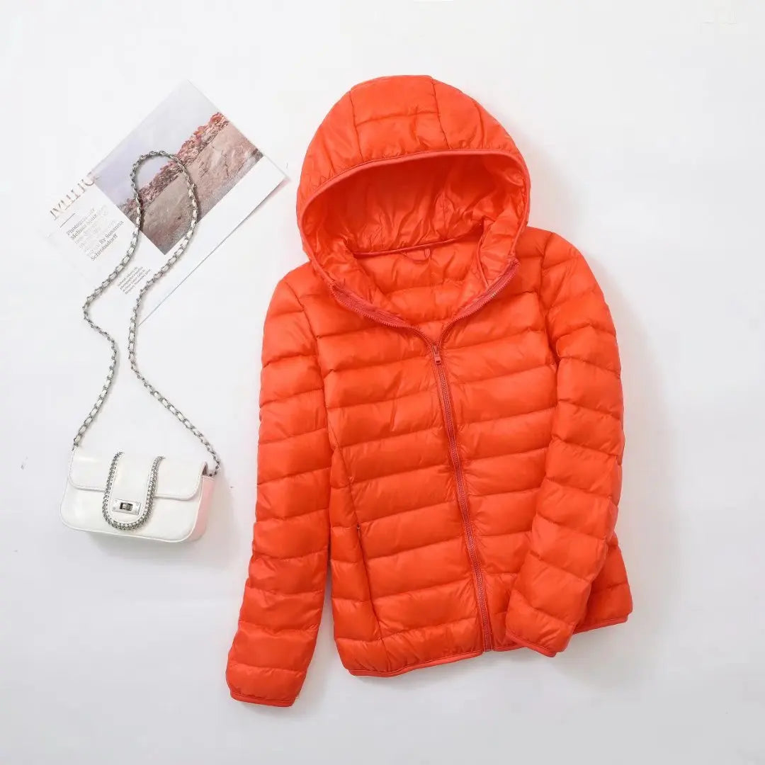 Steppjacke für Damen in Orange mit warmer Kapuze, praktischem Reißverschluss und Wendefunktion