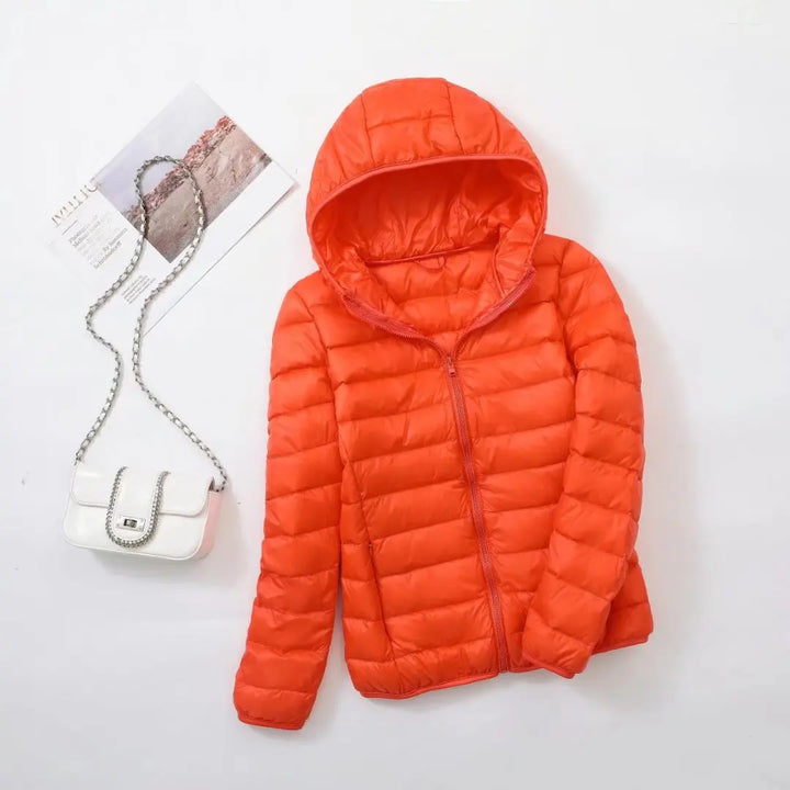Steppjacke für Damen in Orange mit warmer Kapuze, praktischem Reißverschluss und Wendefunktion